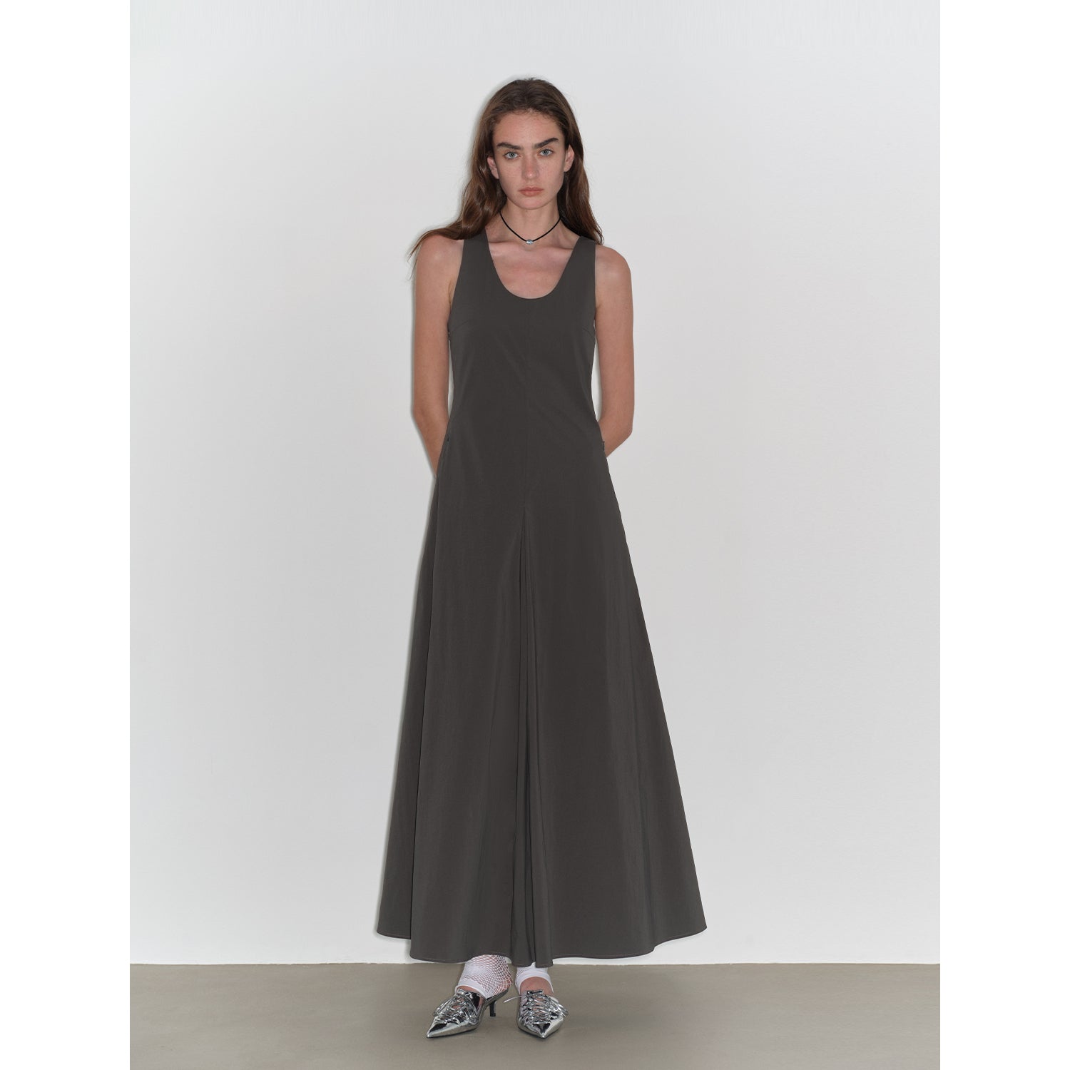 Woman wearing Lakelyn U-Neck A-Line Vest Dress with full skirt and sleeveless design, made from high-density cotton brocade stretch fabric.
