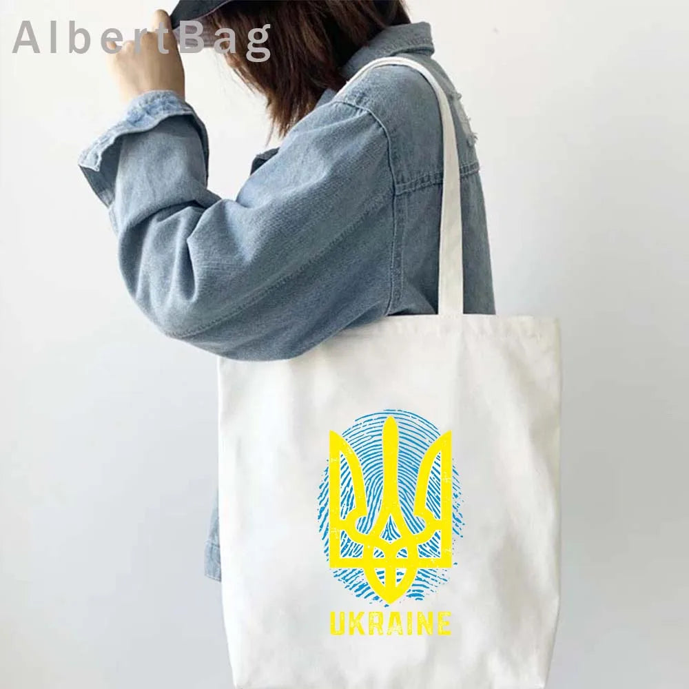 Ukrainian Patriotic Grocery Tote Bag with Ukrainian emblem, eco-friendly cotton, stylish and reusable design for shopping.