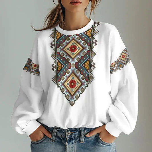 Oversized women's sweatshirt with Ukrainian vishivanka rombus ornament, colorful traditional design on white fabric.