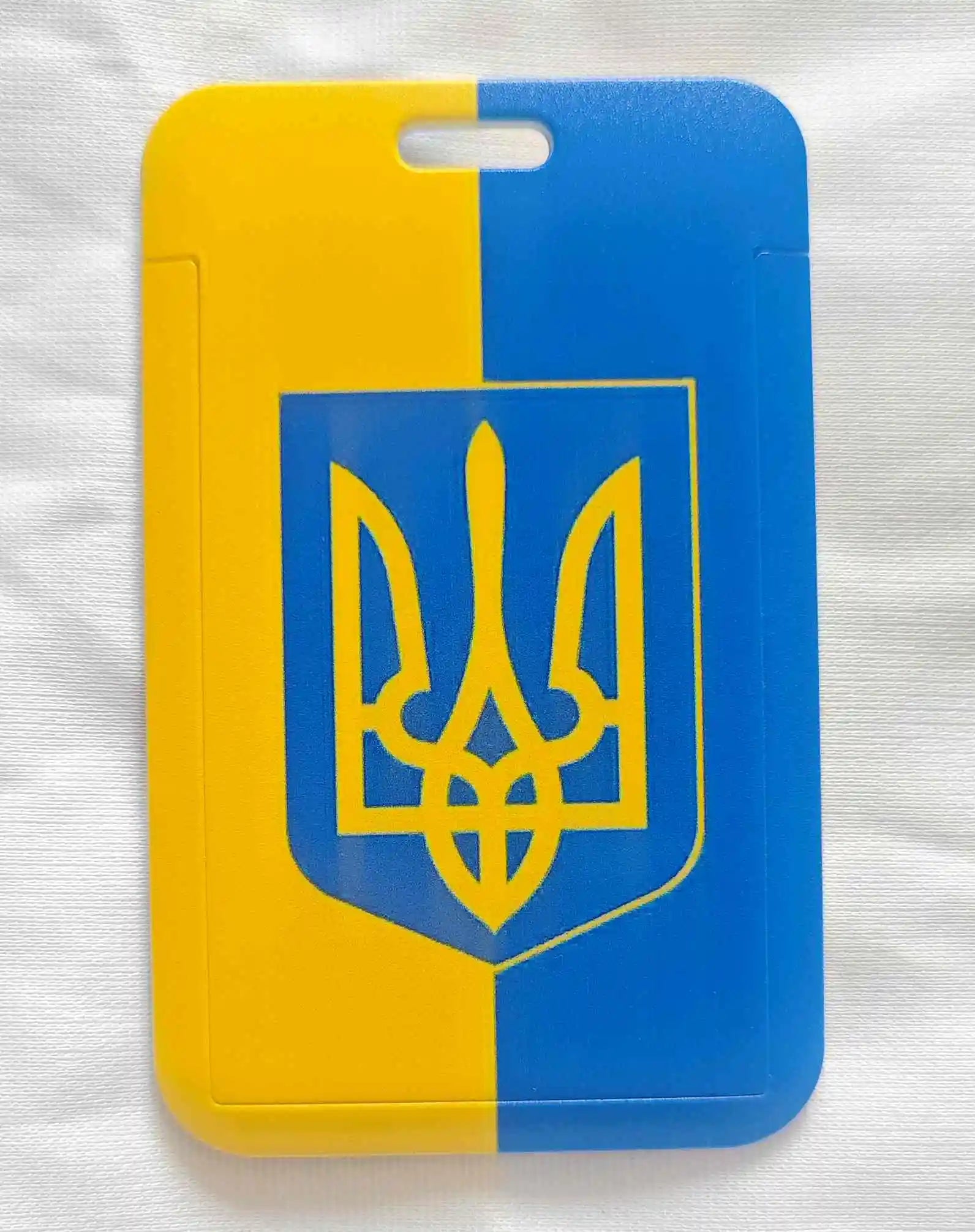 Ukraine cellphone card holder with blue and yellow design, features national emblem, perfect for secure and stylish carrying.