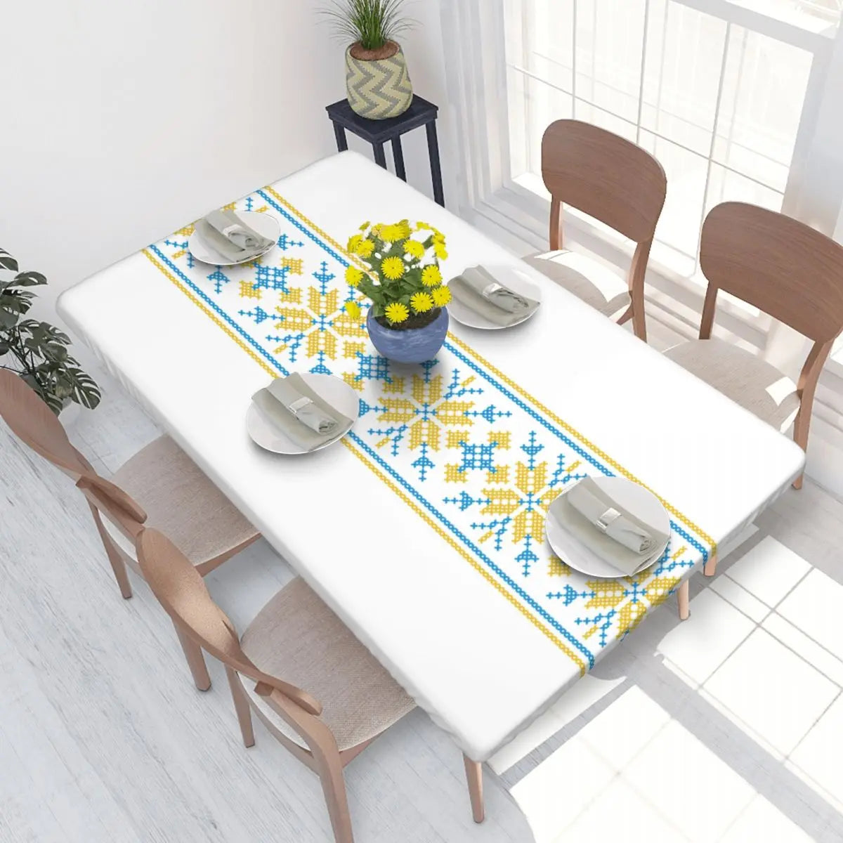 Ukrainian embroidery table cover on dining table, with blue and yellow intricate design, enhancing home decor.