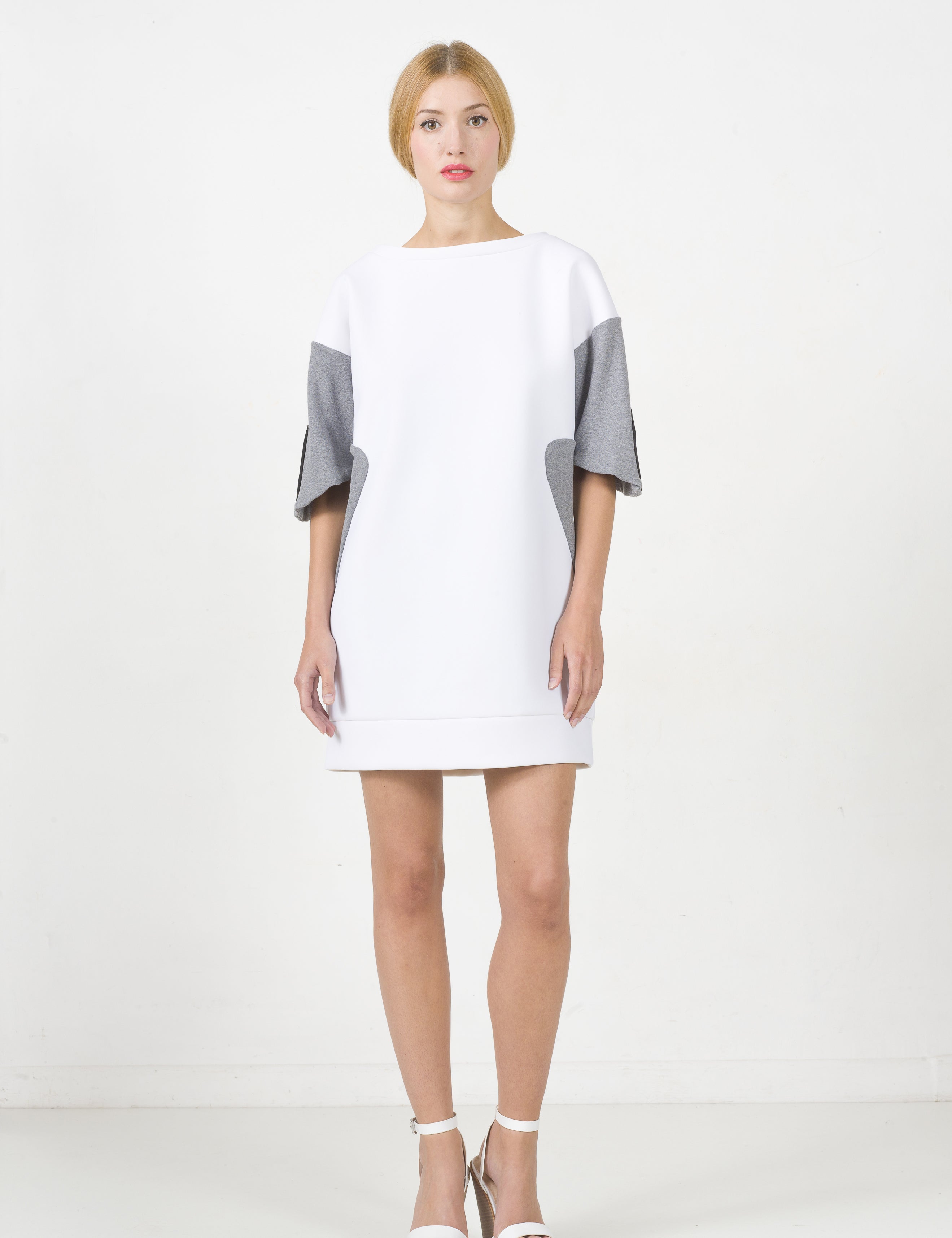 Model wearing Lorvien white neoprene panel dress with contrasting grey sides and sleeves, showcasing a minimalist and modern design.