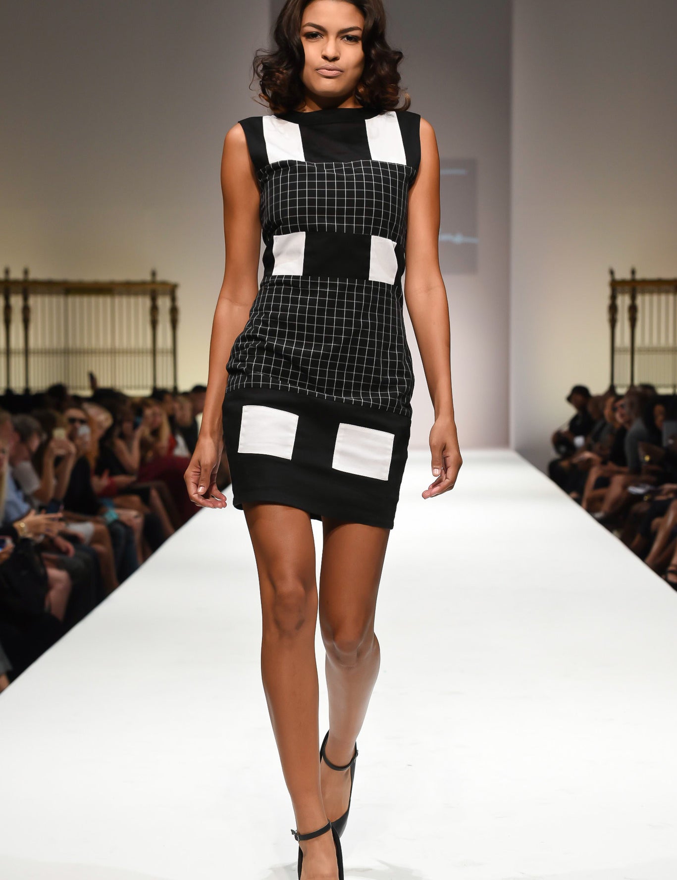 Model wearing a Graphic Edge Colorblock Dress with black and white design, on runway, highlighting structured silhouette and modern style.