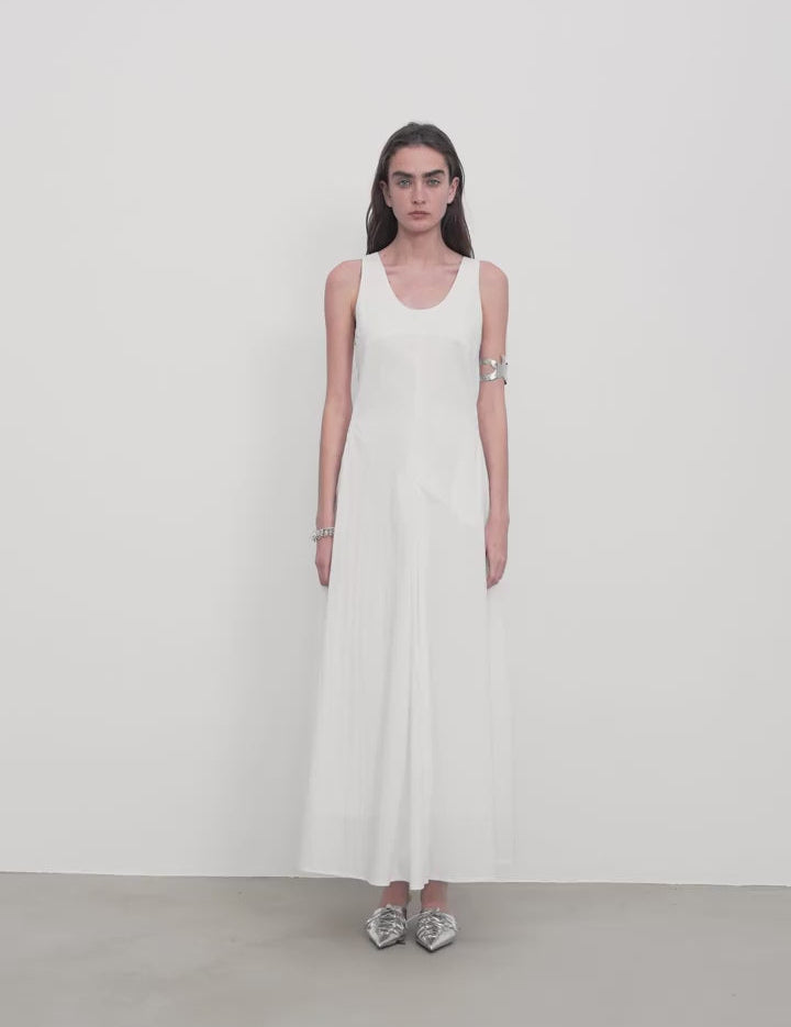 Model wearing Lakelyn U-Neck A-Line Vest Dress in white, featuring a sleeveless design and a full A-line skirt.