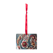 Ukrainian style acrylic ornament with floral design and red ribbon hanger
