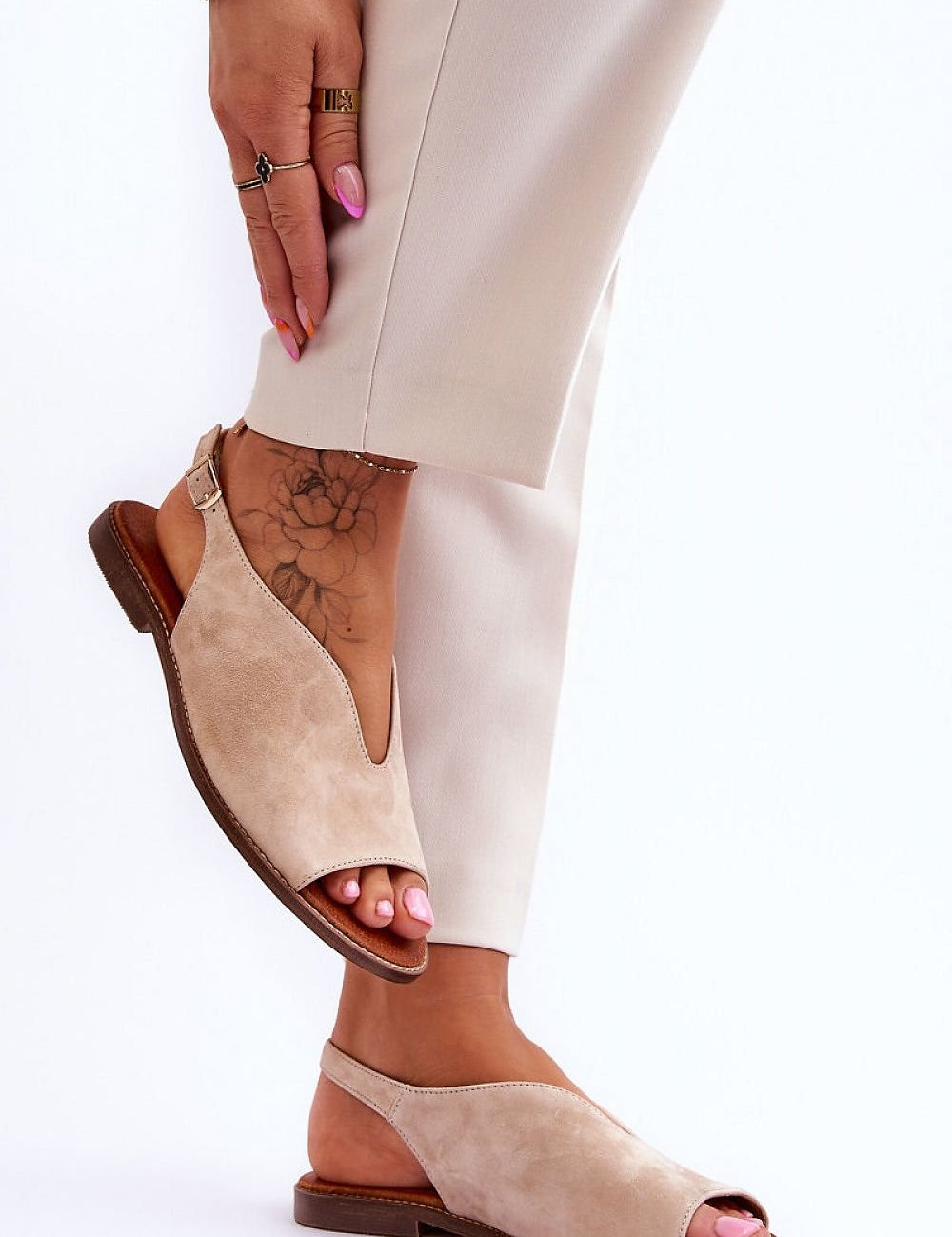 Alcira Stitched Leather Flat Sandals on foot, showcasing elegant stitched trim, soft leather insole, and adjustable buckle strap for comfort.
