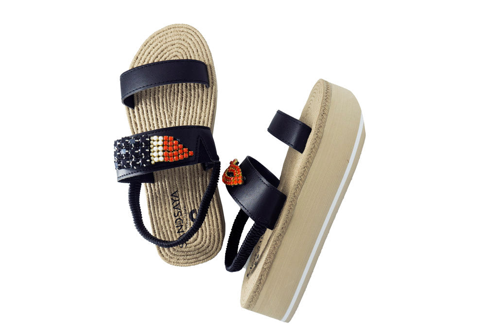 Black espadrille wedge sandals with embroidered red lips and cushioned sole.