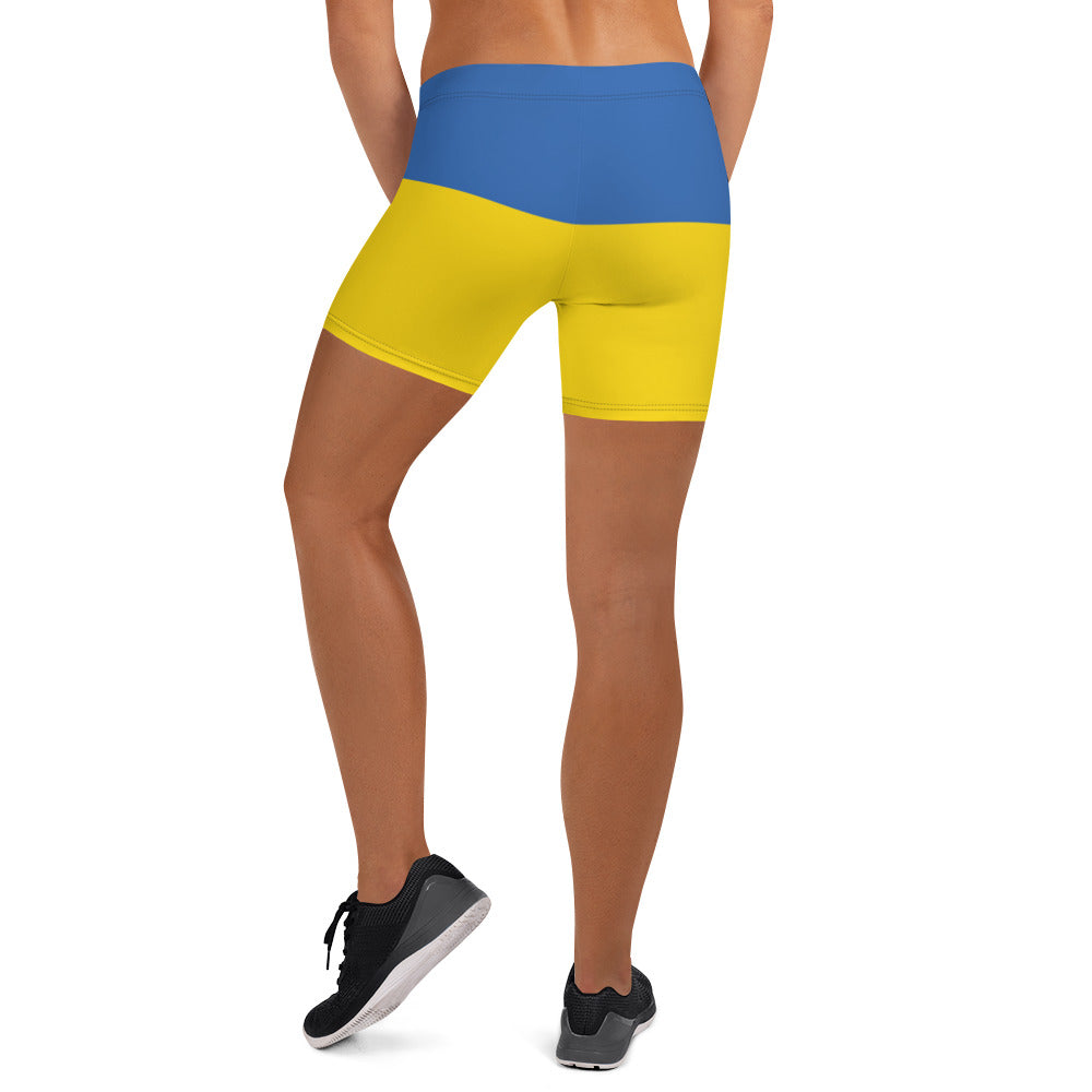 Woman wearing Ukrainian Flag shorts from Ukrainian Vibe Trizub Collection, featuring vibrant blue and yellow design, perfect for active wear.