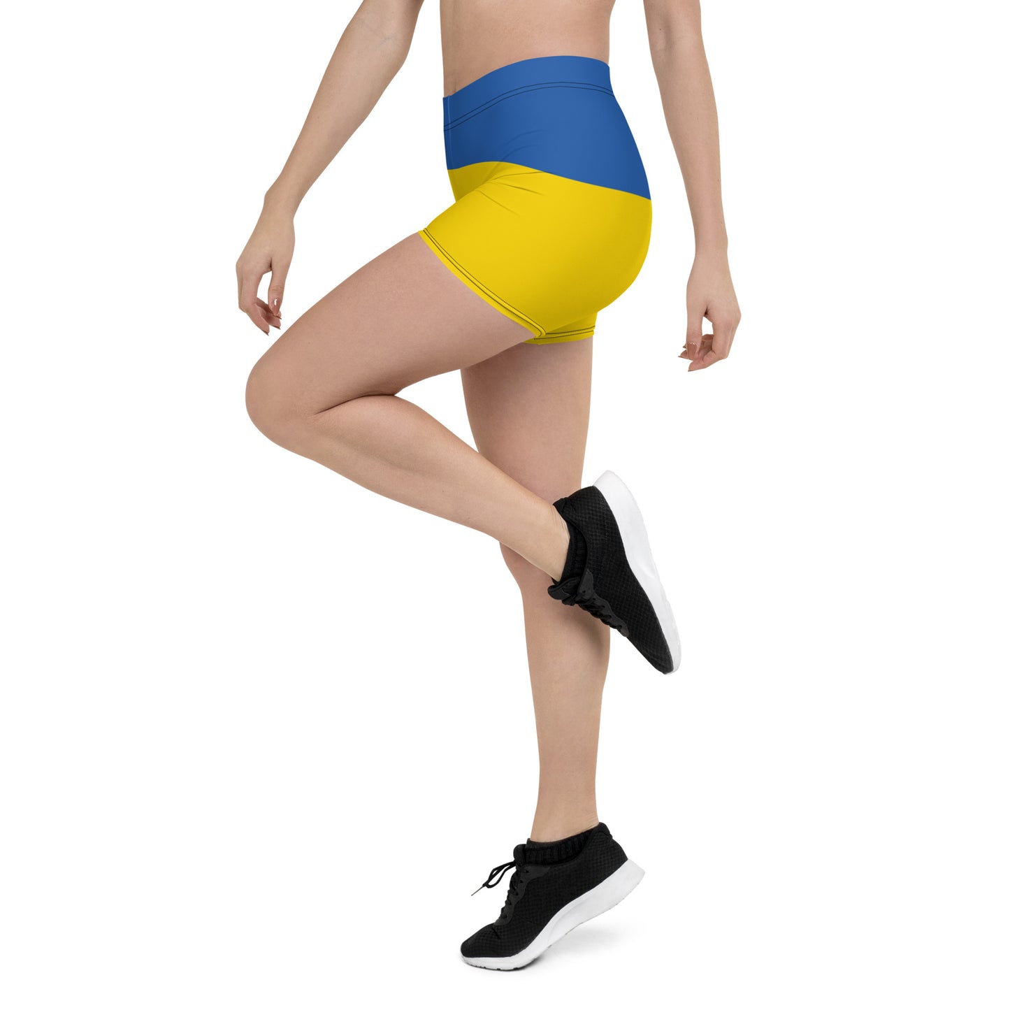 Woman wearing blue and yellow Ukrainian Flag shorts, showcasing comfort fit and vibrant design, part of Ukrainian Vibe Trizub Collection.