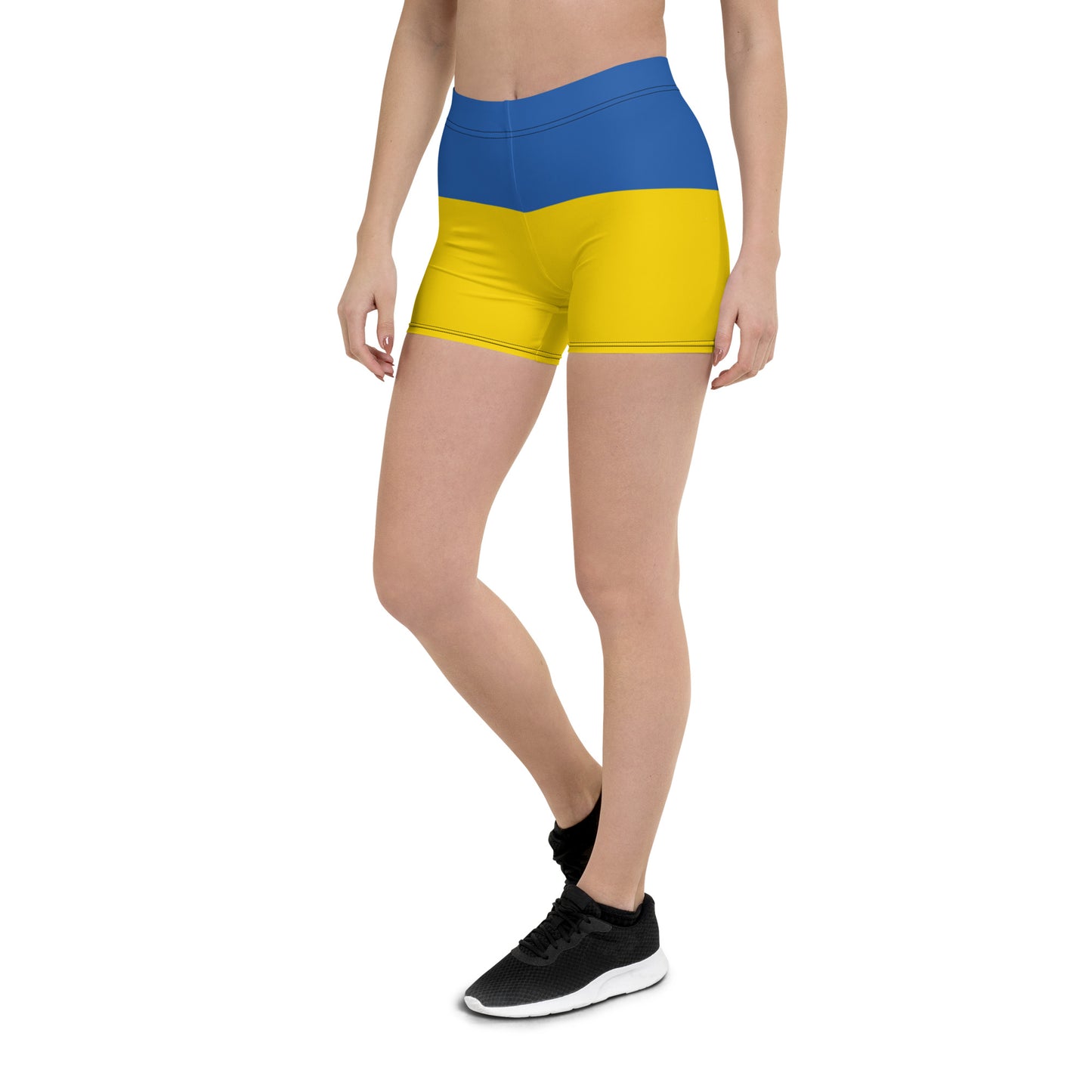 Woman wearing Ukrainian Flag shorts from Ukrainian Vibe Trizub Collection, featuring blue and yellow design with four-way stretch fabric.