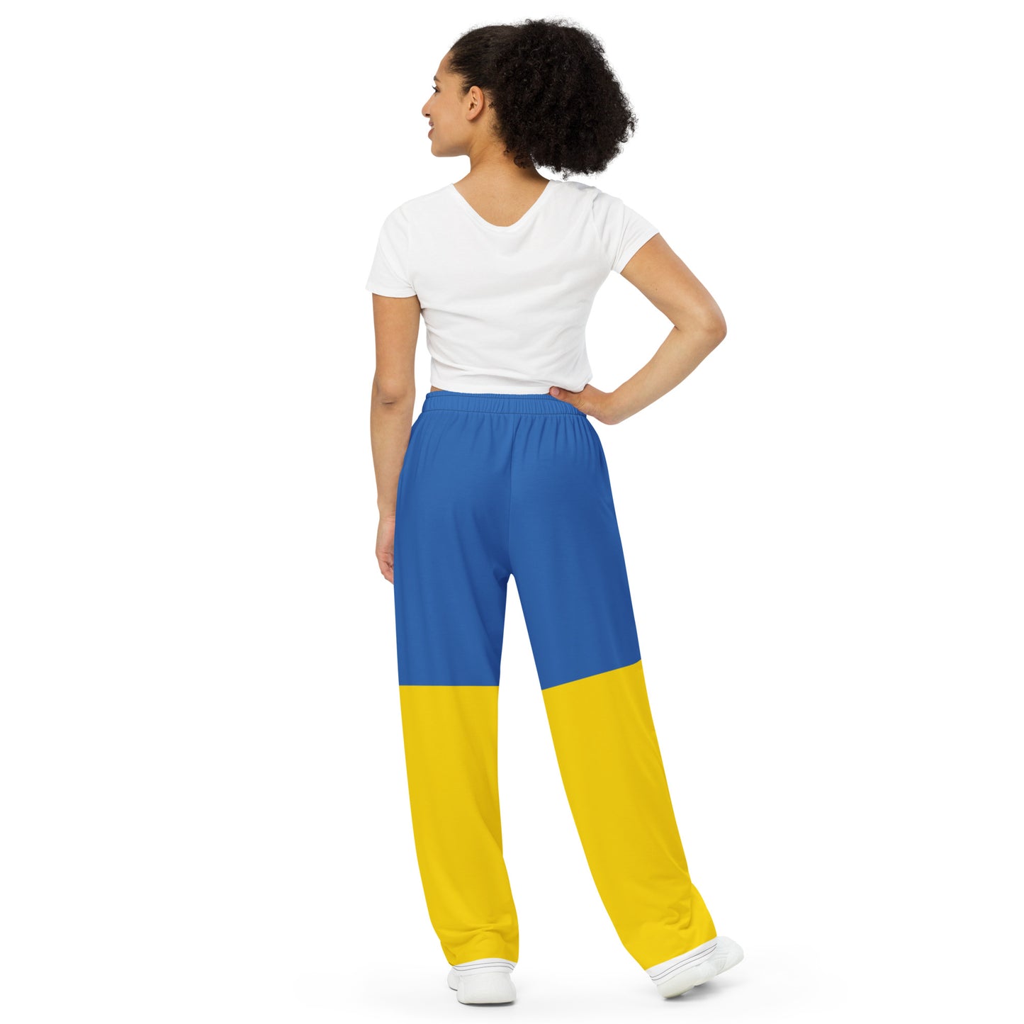 Woman wearing Ukrainian Flag wide-leg pants with blue and yellow design, from the Ukrainian Vibe Trizub Collection.