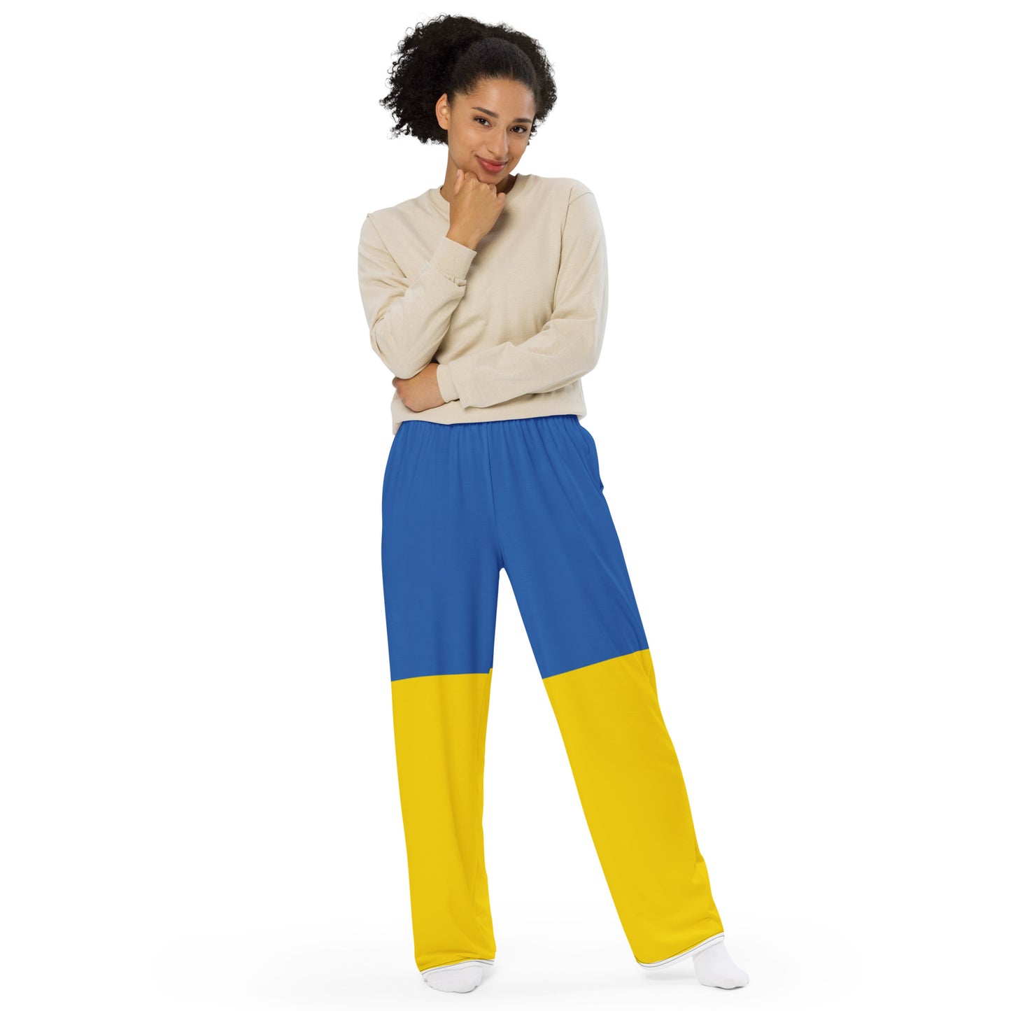 Woman wearing Ukrainian Flag wide-leg pants with adjustable waist, showcasing blue and yellow design, from the Ukrainian Vibe Trizub Collection.