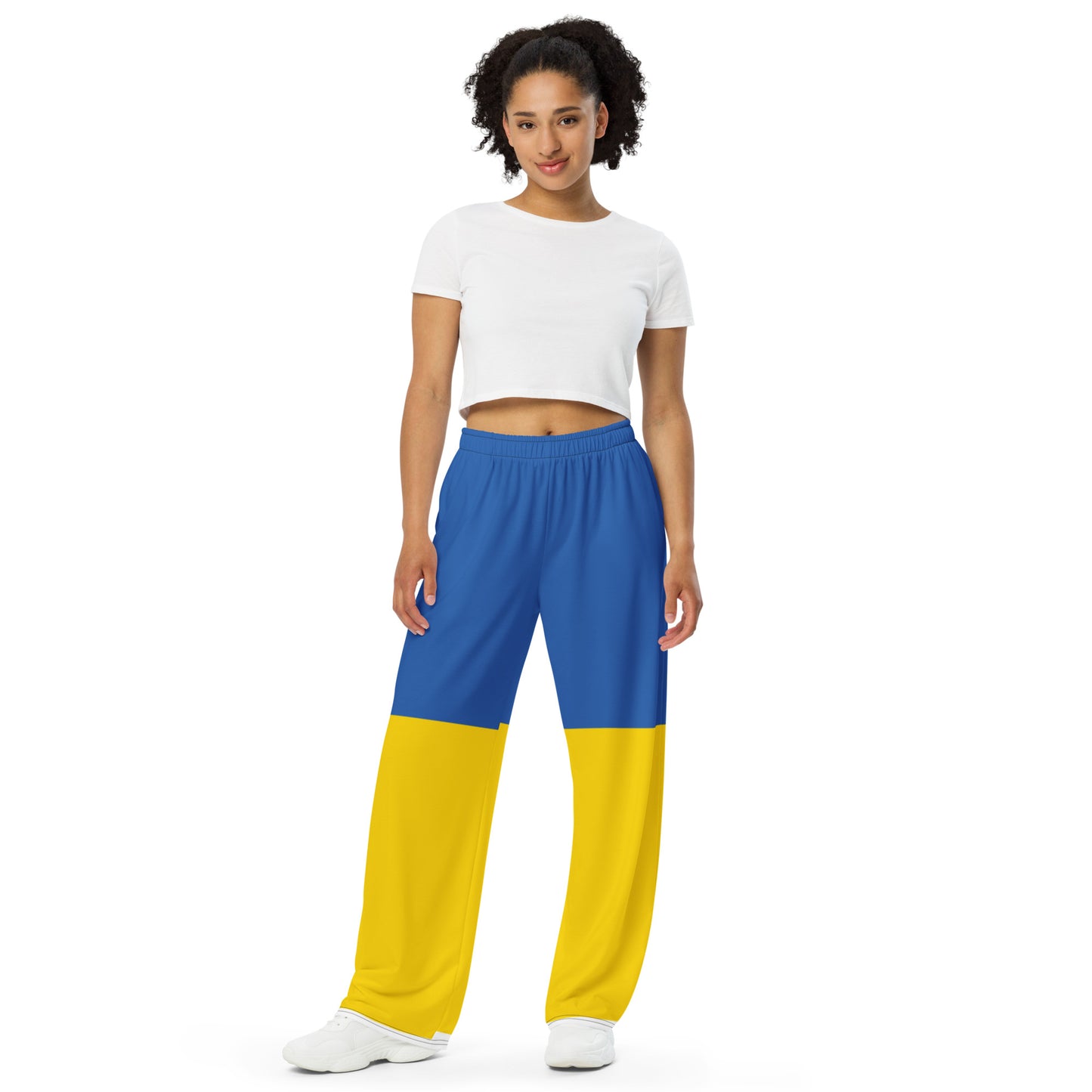 Woman wearing Ukrainian Flag wide-leg pants from the Ukrainian Vibe Trizub Collection, showcasing a stylish and comfortable design.