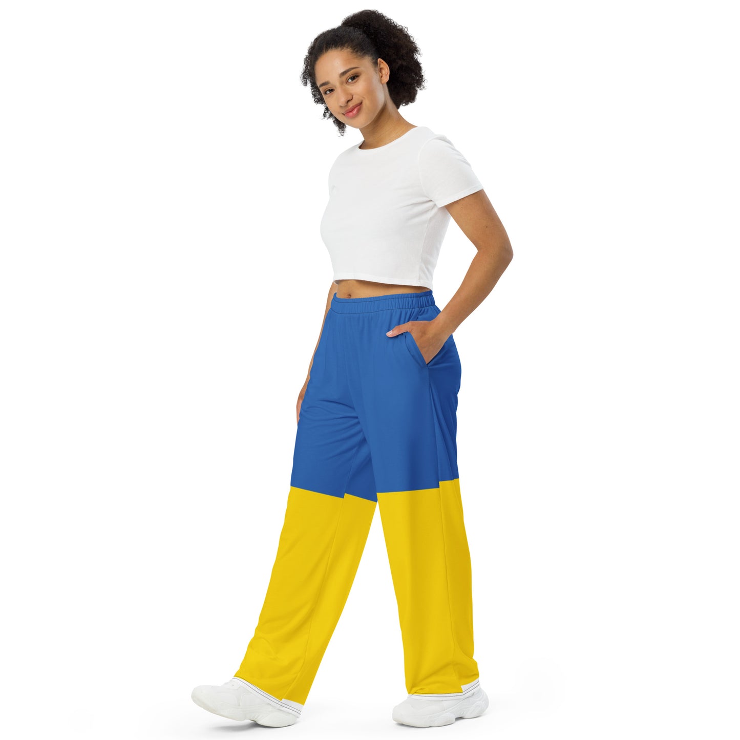 Woman wearing Ukrainian Flag wide-leg pants with blue and yellow design, part of the Ukrainian Vibe Trizub Collection.