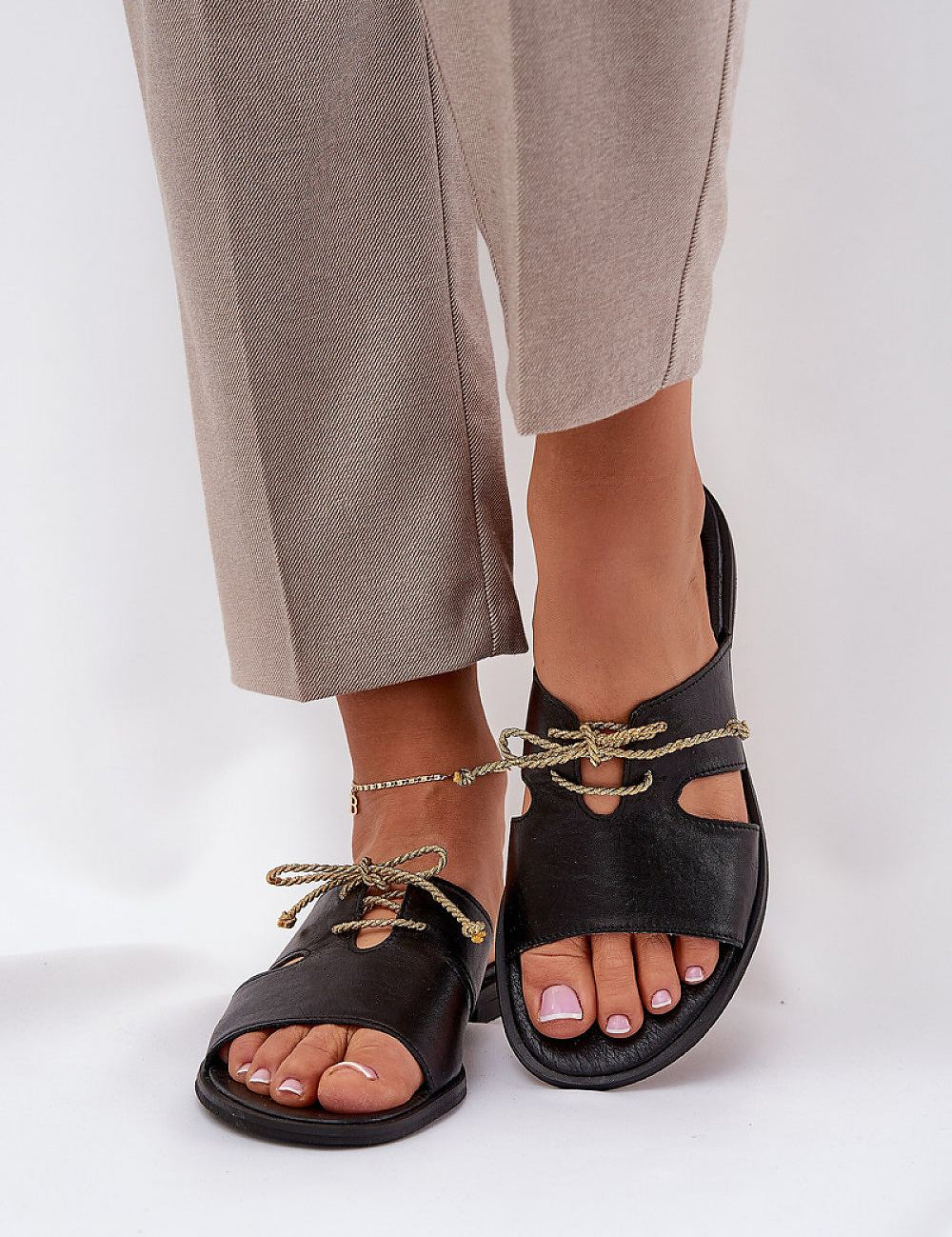 Alvessa Gold Accent Leather Slides with delicate golden string detail, worn by person, showcasing elegant style and comfort.