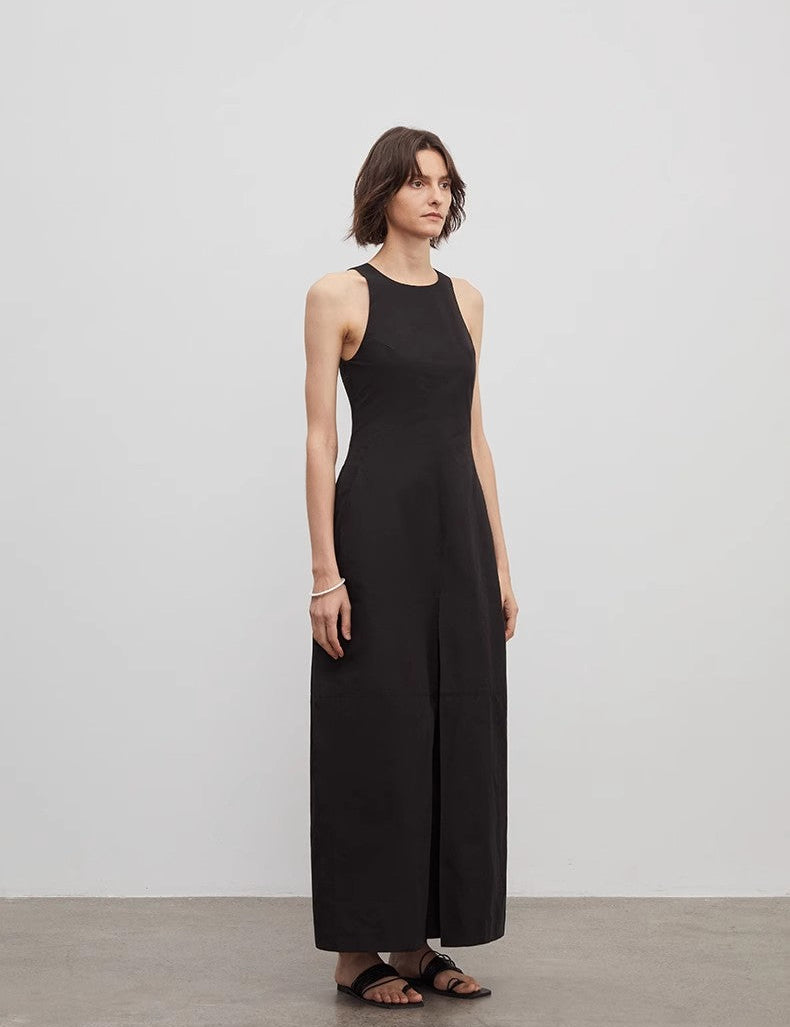 Arclaire sleeveless A-line dress in black, minimalist design showcasing French elegance with an architectural cut for graceful movement.