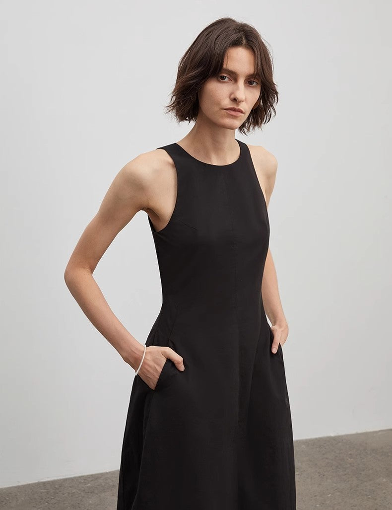 Model wearing the Arclaire Sleeveless A-Line Dress in black, showcasing its minimalist design and flattering silhouette.