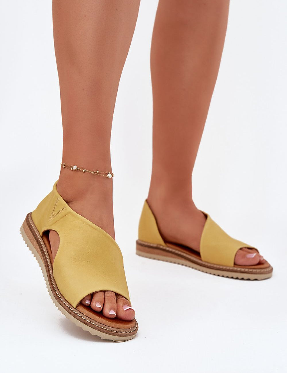 Yellow leather open-toe sandals with covered heel, featuring lightweight and stylish design for all-day comfort and support.