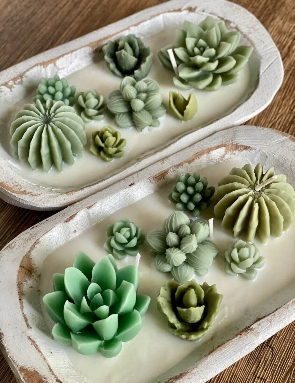 Handcrafted Solterre garden candle in a carved wooden bowl with succulent-shaped wax design, made from organic soy wax.