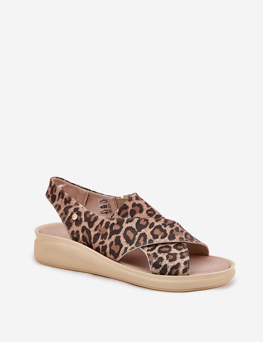 Leopard print Arlienne leather platform slip-on sandal with elastic band and decorative emblem on the upper, on a beige platform wedge.
