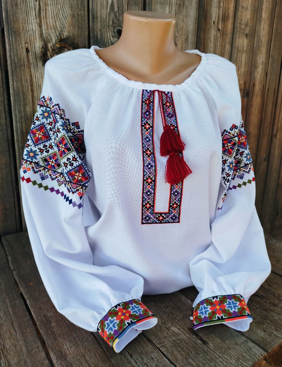 Authentic Ukrainian vyshyvanka, women's embroidered blouse on white homespun fabric with folk ornamentation.