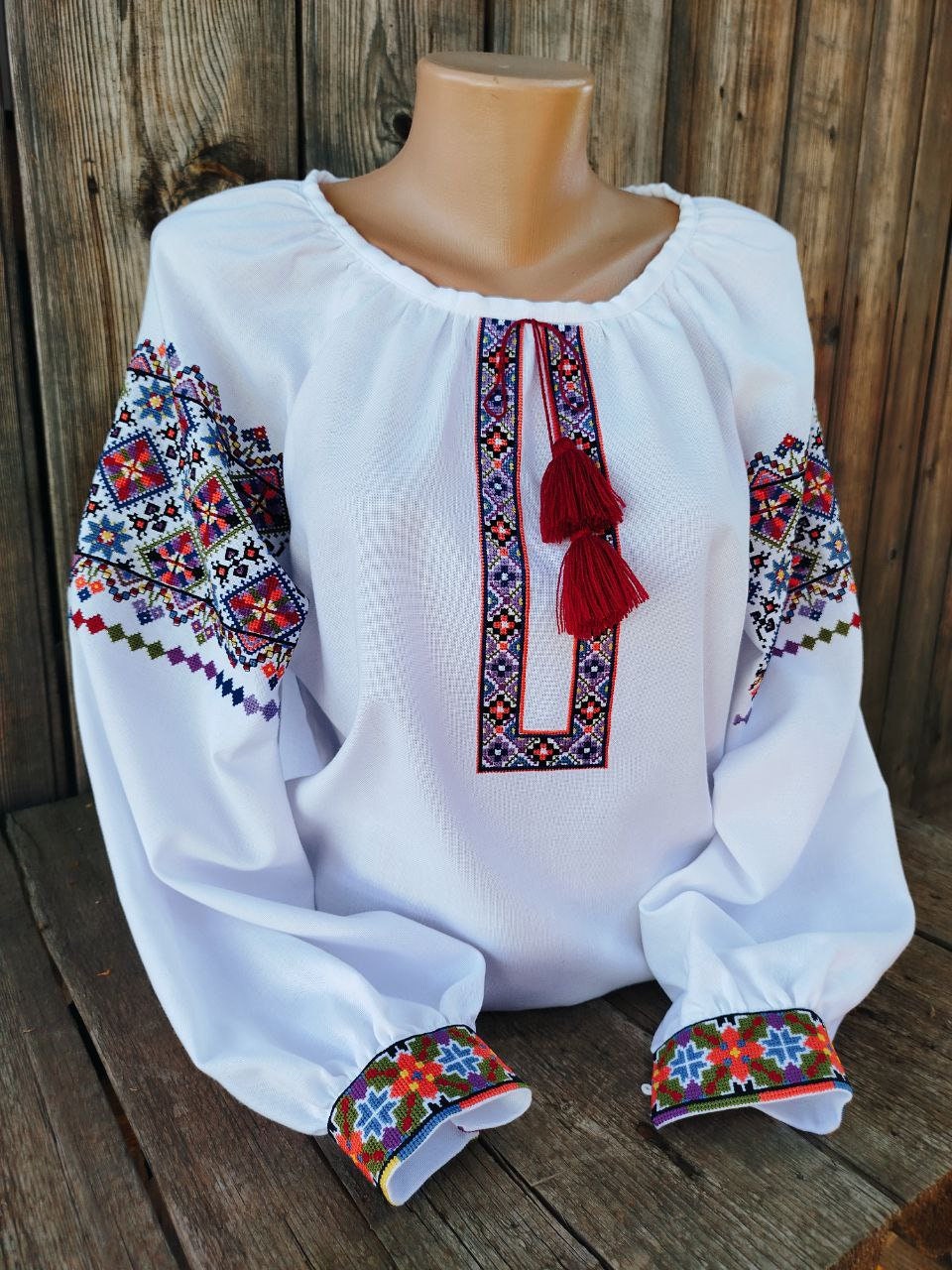 Authentic Ukrainian vyshyvanka, women's embroidered blouse on white homespun fabric with folk ornamentation.