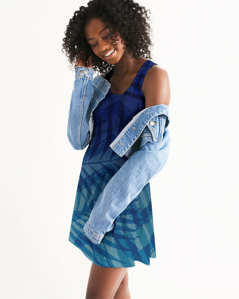 Woman wearing a blue Sunset Hour Racerback Dress with a denim jacket, showcasing its relaxed fit and casual charm.