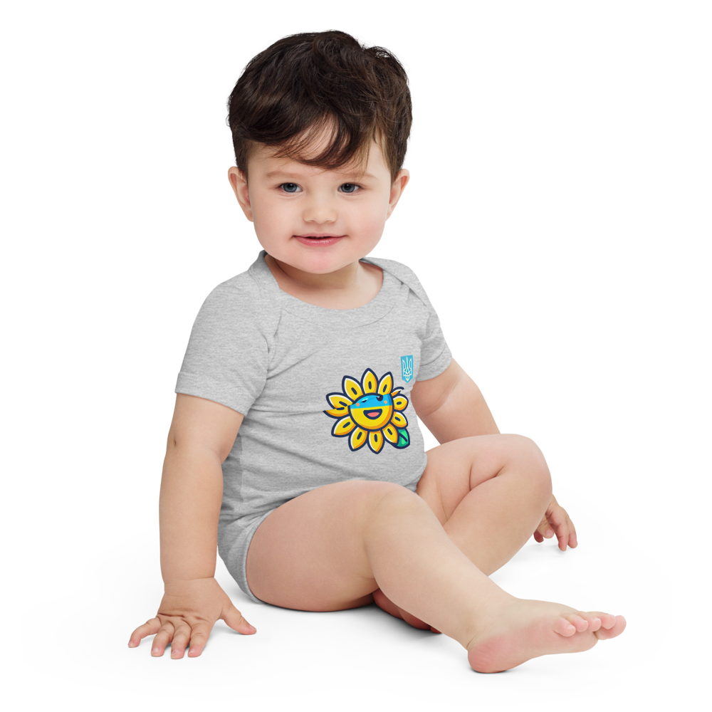 Baby wearing sunflower and Ukrainian flag bodysuit, sitting and smiling, soft cotton baby clothing for Ukrainian families
