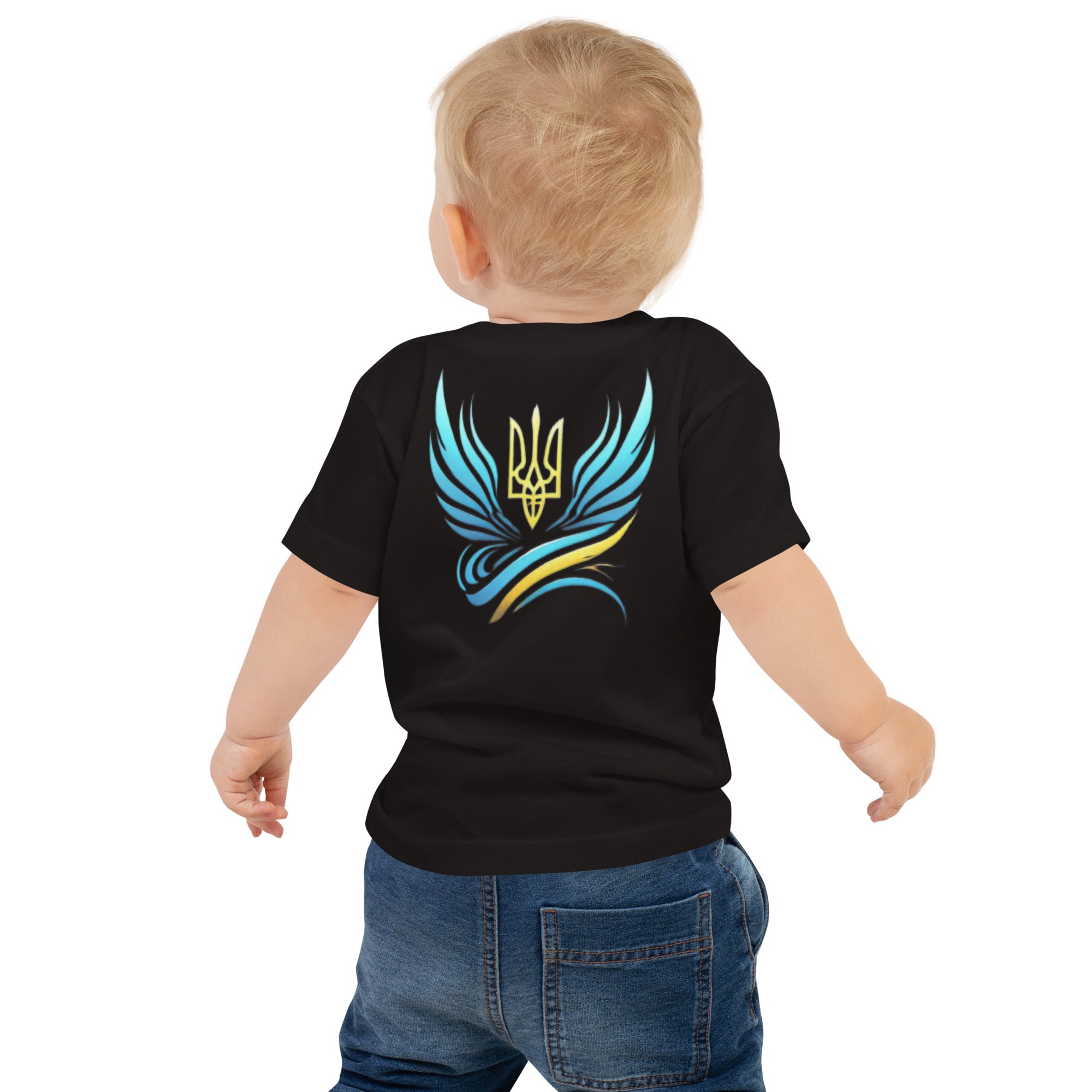 Baby wearing black jersey tee with colorful Ukrainian symbol design on the back.