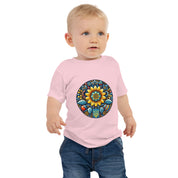 Baby wearing pink jersey tee with Ukrainian symbol design, made of soft cotton for comfort and durability.