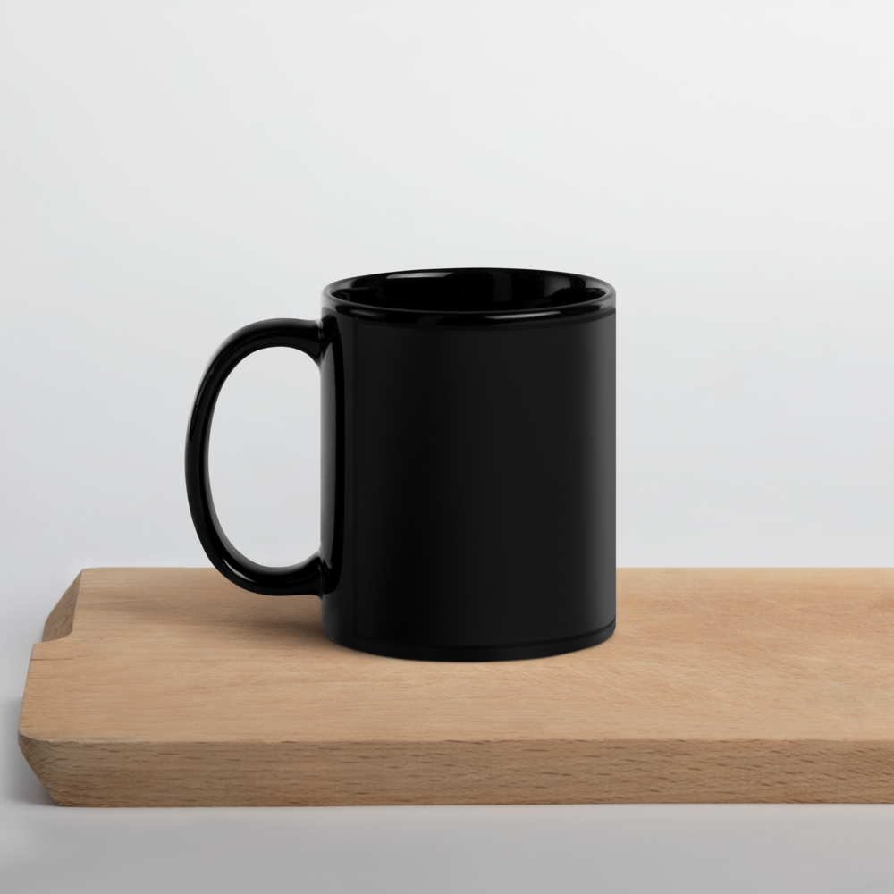 Elegant black ceramic mug with Ukrainian Tryzub design on a wooden board, perfect for coffee or tea.
