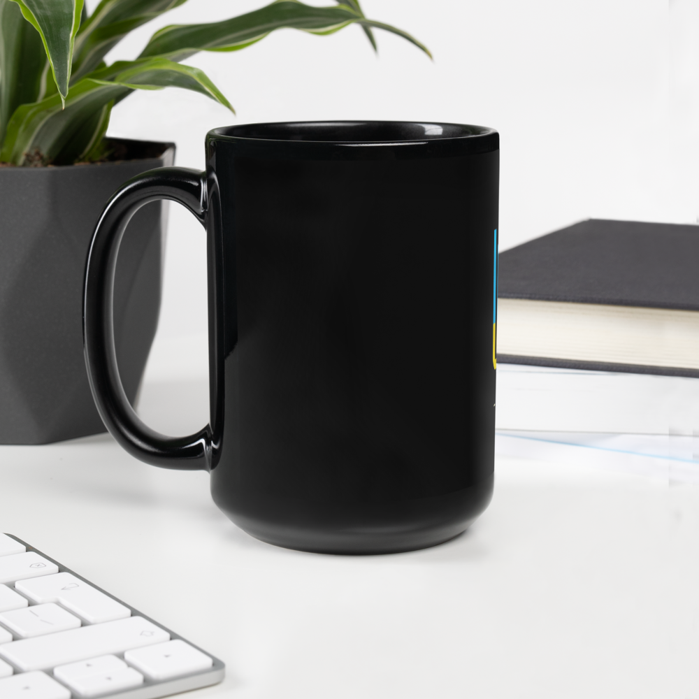 Black ceramic mug featuring Ukrainian Tryzub emblem, elegant glossy finish, ideal for coffee or tea, shown on desk with plant and book.