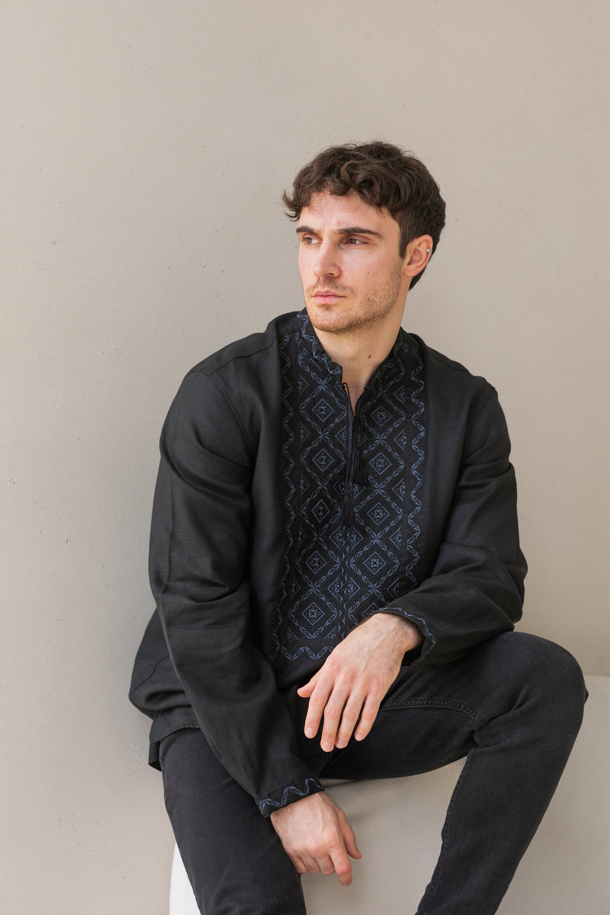 Man wearing black linen Ukrainian vyshyvanka with Poltava embroidery