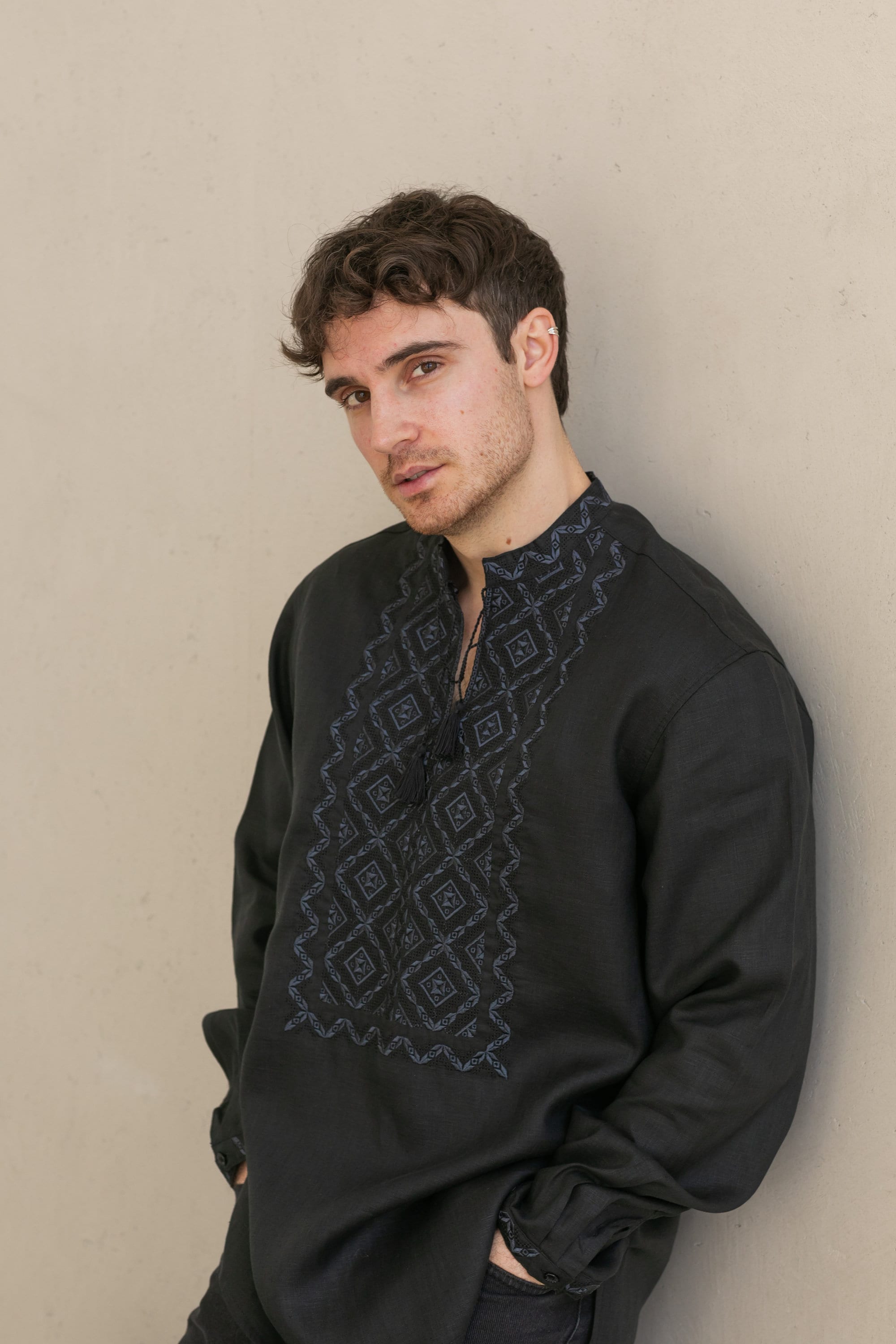 Black linen men's shirt with traditional Ukrainian Poltava embroidery, featuring refined black-on-black cross-stitch design.