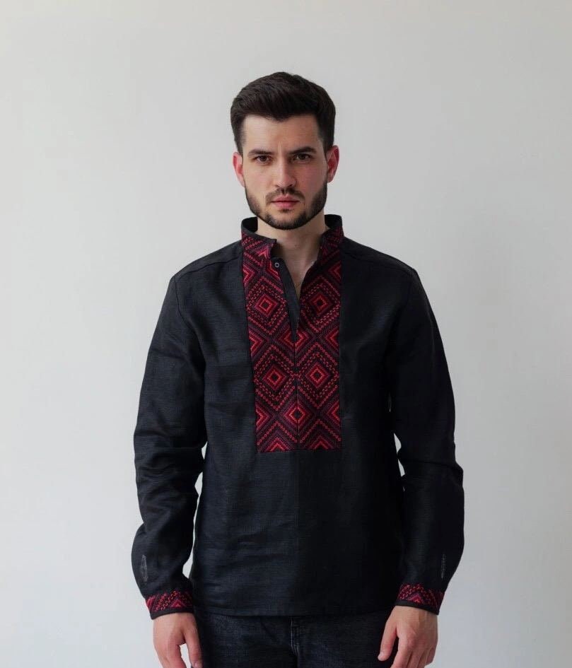 Black linen men’s shirt with red geometric embroidery, featuring Ukrainian Vyshyvanka design and a stand-up collar.