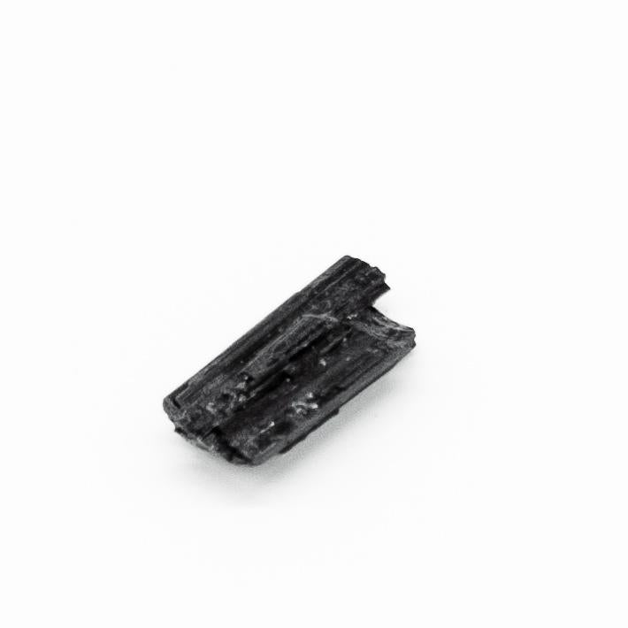 Black tourmaline fragment for grounding energy and protection, pocket-sized stone, charged under full moon, absorbs negative energy.