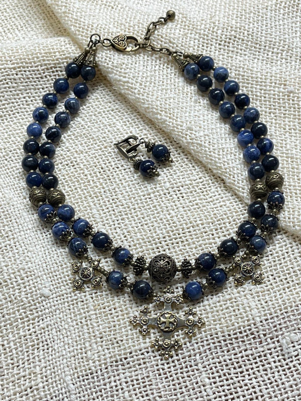 2025 Blue Ukrainian Necklace "Magic of the Night" with sodalite stones and bronze accents on textured fabric background.