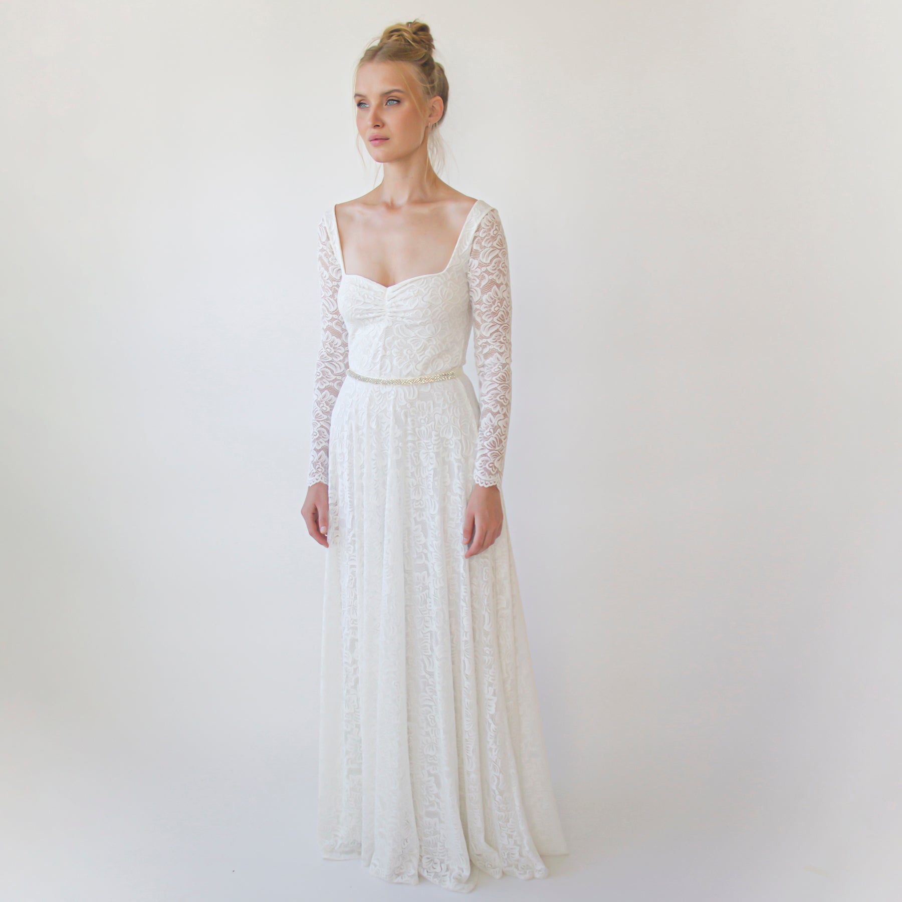 Bride wearing Virelle Crystal Ribbon Bridal Belt with lace wedding gown, showcasing elegant satin sash and sparkling rhinestone details.