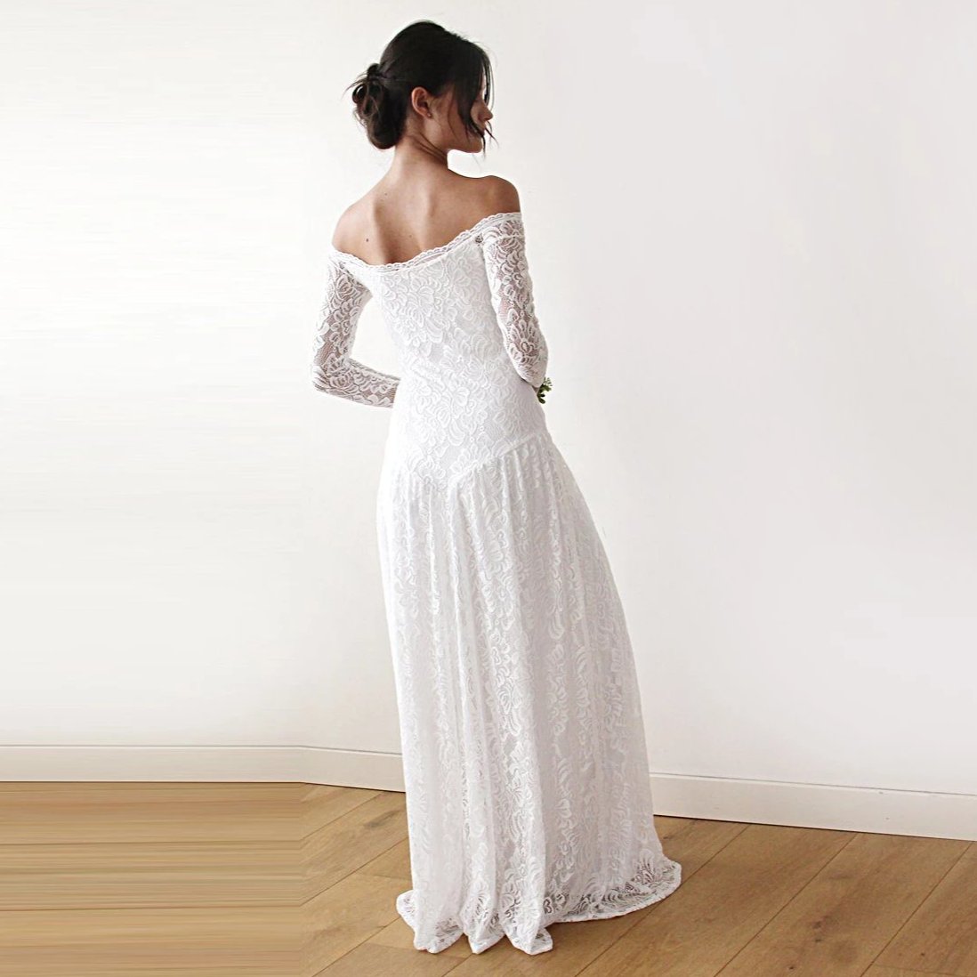 Back view of Elverin medieval lace wedding dress with off-the-shoulder neckline and elegant train in ivory.