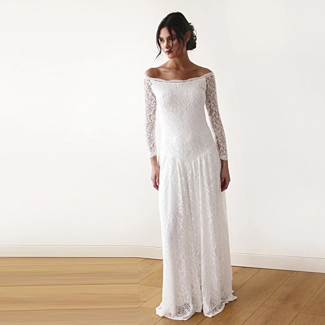 Bride wearing Elverin medieval lace wedding dress with off-shoulder neckline and regal train, capturing ethereal elegance in ivory.