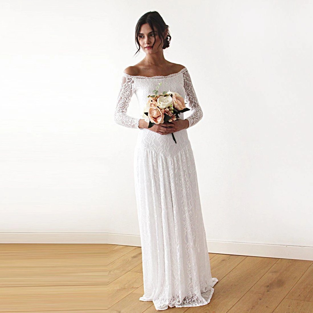Bride wearing the Elverin Medieval Lace Wedding Dress with off-the-shoulder neckline and holding a bouquet.