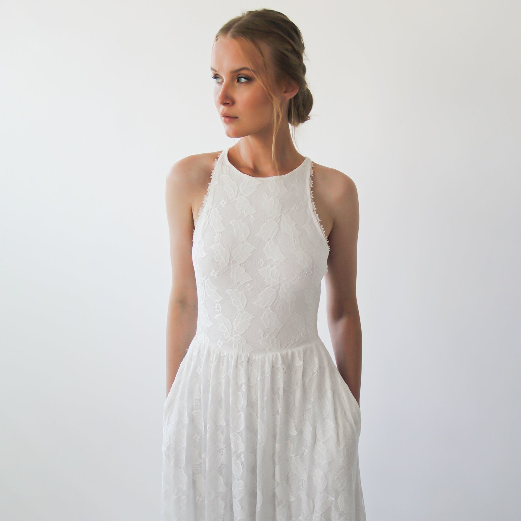 Bride wearing Serenelle Halter Wedding Dress with elegant sleeveless design and flowing ivory fabric, ideal for minimalist weddings.