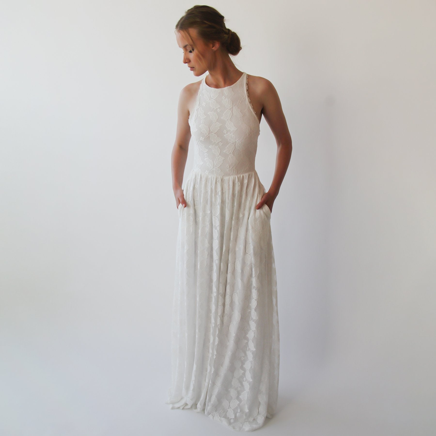 Serenelle Halter Wedding Dress with sleeveless design and flowing ivory fabric for an elegant and minimalist bridal look.