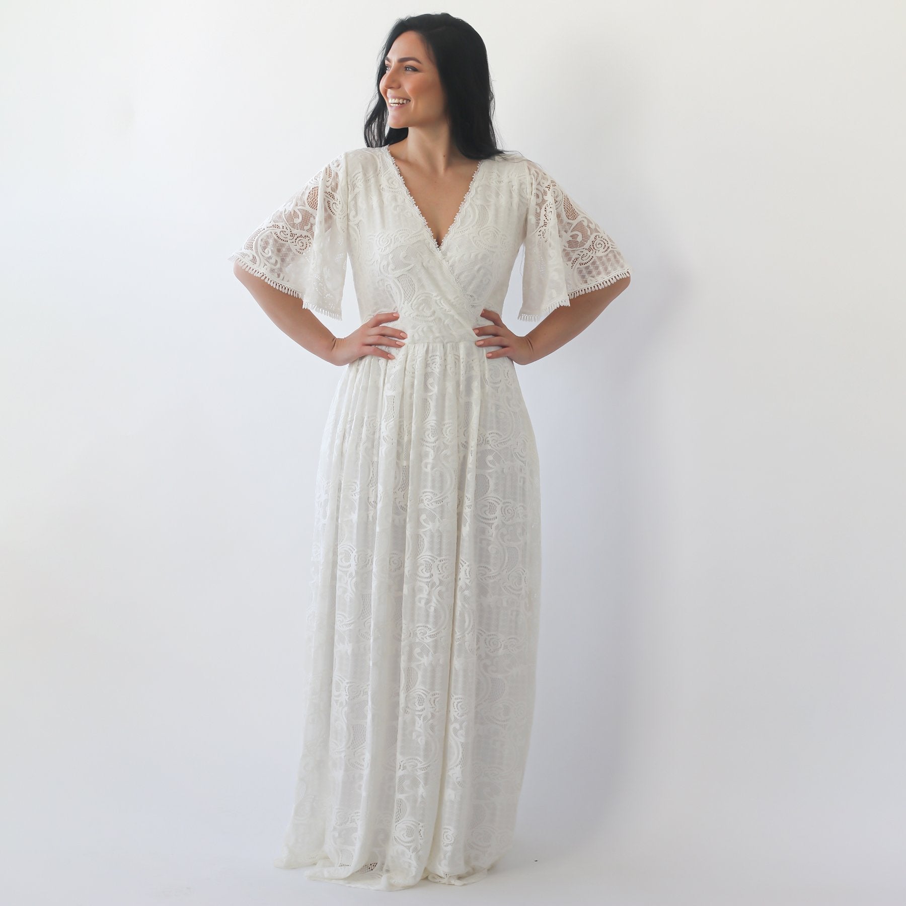 Woman wearing Elanora Ivory Lace Gown with Butterfly Sleeves, V-neckline, and full-length elegant silhouette on a neutral background.