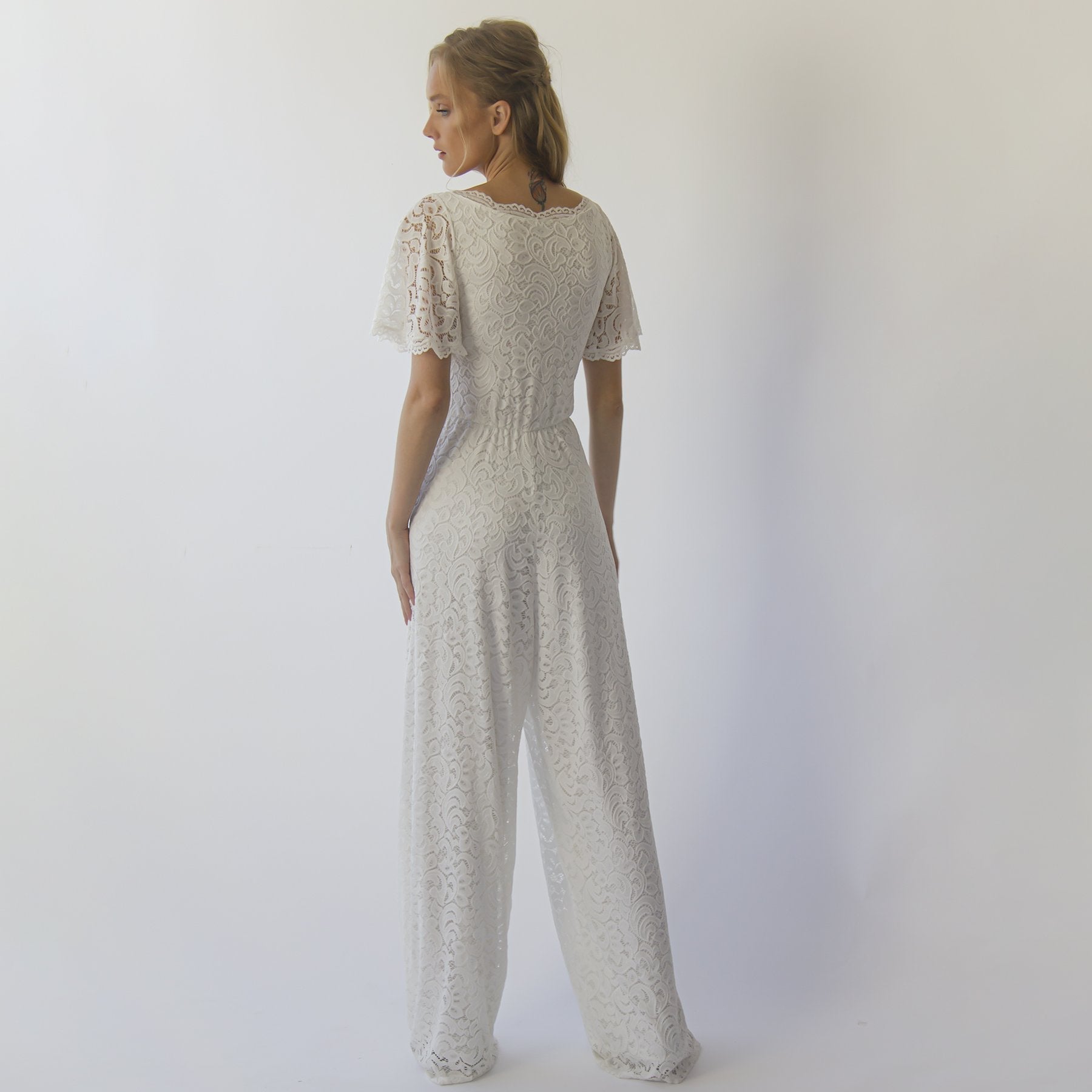 Back view of Ivarelle Bridal Lace Jumpsuit, featuring ivory stretch lace and elegant floor-length design with short sleeves.