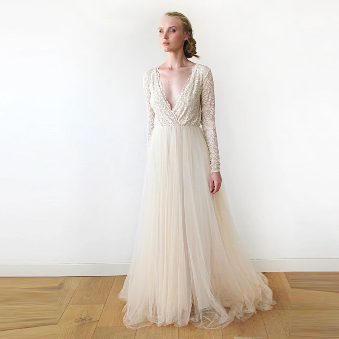 Celivara champagne lace gown with sheer sleeves and long silk-tulle train on bride, showcasing elegant drape and romantic style.