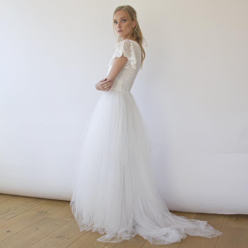 Selvienne Puffy Tulle Wedding Dress with cap sleeves and dramatic train, perfect for elegant garden ceremonies.
