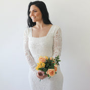Woman in Elirelle ivory lace wedding dress with sleeves holding bouquet, showcasing elegant mermaid silhouette and square neckline.