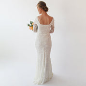 Back view of Elirelle ivory lace wedding dress with sleeves, featuring a square neckline and mermaid silhouette.