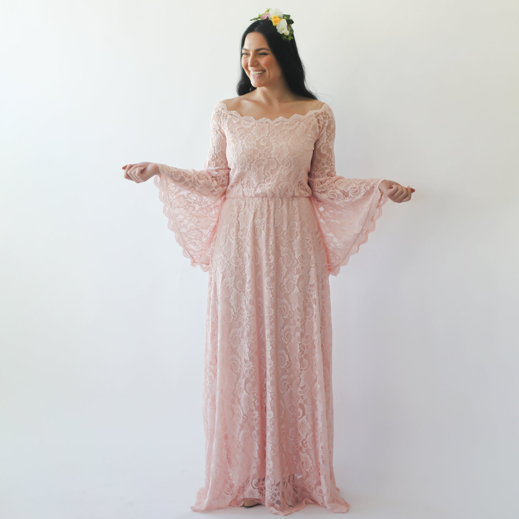 Bride wears Elidoria off-shoulder blush lace wedding dress with long bell sleeves, showcasing elegant bohemian style.